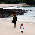 Baby walking down unknown beach